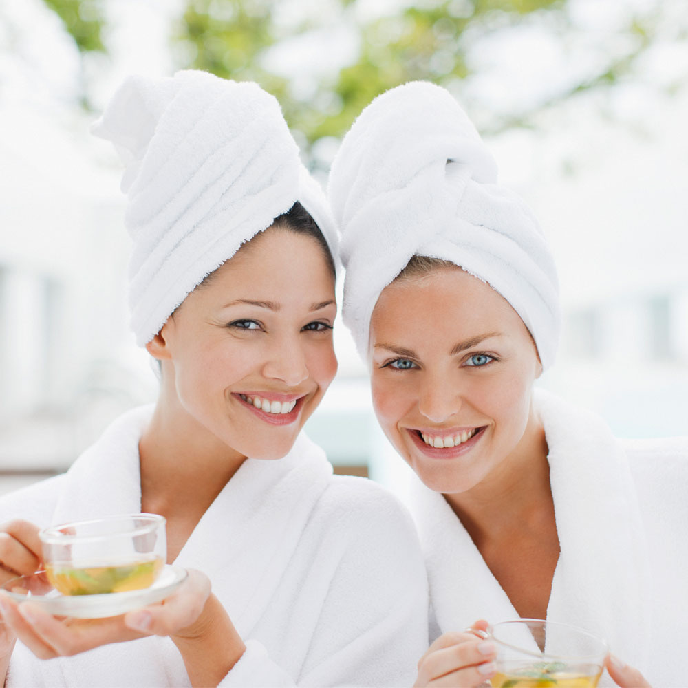 Elevation Med Spa Lone Tree Colorado two women enjoying a spa day with robes and towels wrapped on head