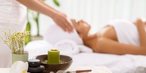 Elevation Med Spa Lone Tree Colorado blurry view of woman receiving massage with candle in foreground