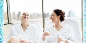 Elevation Med Spa Lone Tree Colorado two women in robes enjoying a spa day laughing