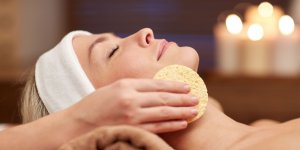 Elevation Med Spa Lone Tree Colorado woman finishing facial with sponge wiping off product